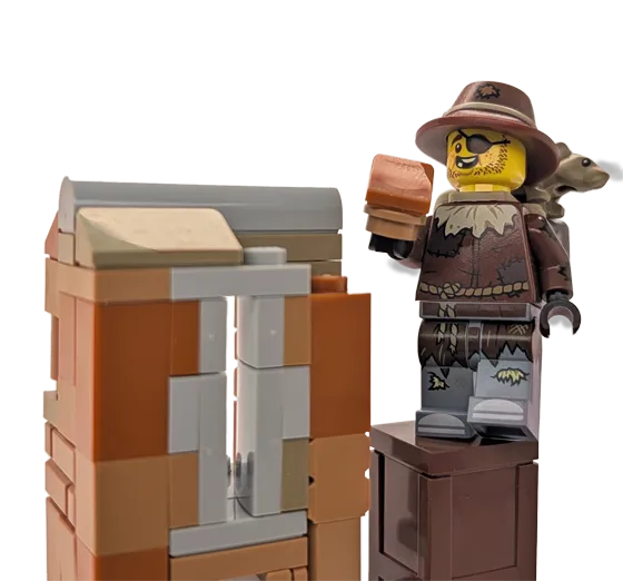 Rusty Dusty standing beside a brick-built display while holding a small brown brick